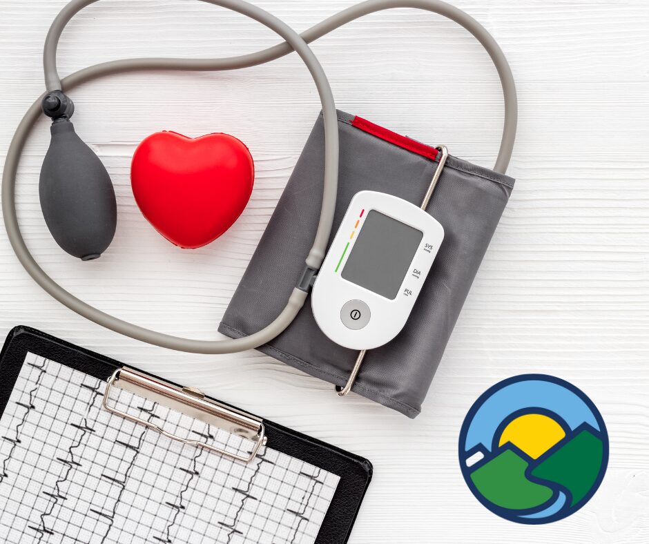 picture of a blood pressure monitor and tracking sheet with a red heart graphic